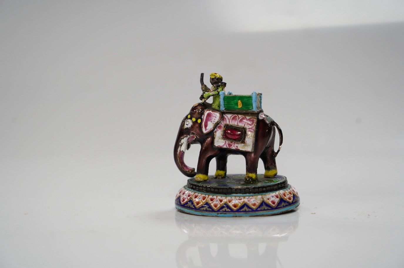 An Indian enamelled white metal elephant and mahout, 5cm. Condition - good